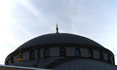 Dome of a mosque with the half moon symbol on top.