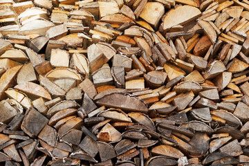 stack of firewood for home heating as a wooden textured backdrop