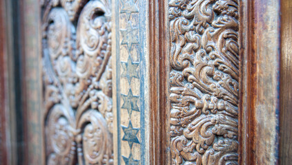 detail of a wooden door with wood carving 