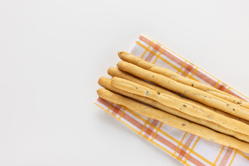 Italian Grissini Breadsticks with olive pieces on white background