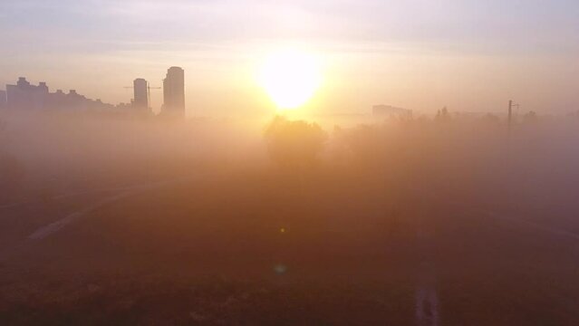 drone takes off through the fog view of the city