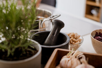 beans in bowl and vegetables in background, pestle on white kitchen table, blurred cozy kitchen background, kitchen poster, food advertisement