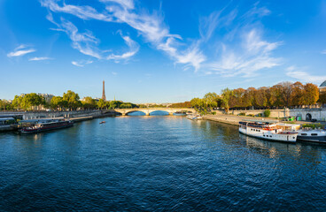 Fototapeta premium Sunny riverside panorama of Pont Alexandre III bridge with Eiffel Tower in the background in Paris. France