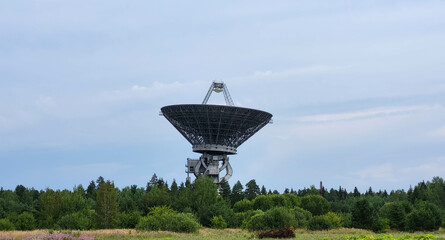 The silhouette of a satellite dish or radio antenna. Space observatory or air defense radar