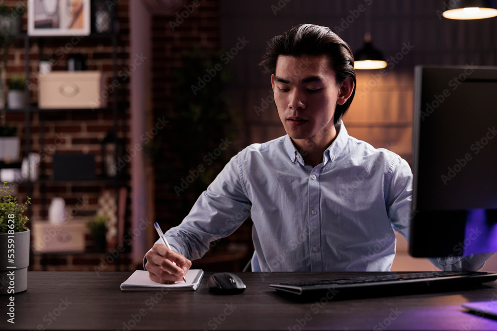 Poster office worker taking notes on files, working on paperwork documents to plan business report remotely