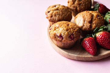 Strawberry muffins served in a plate on a pink background. - 535918835