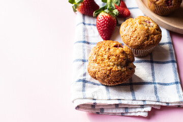 Strawberry muffins on a napkin on a pink background. Copy space. - 535918839