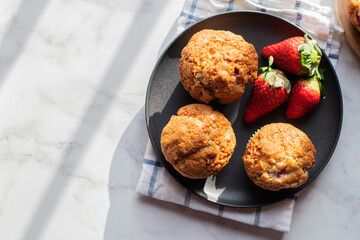 Strawberry muffins served in a plate on a marble background. Top view and copy space. - 535918858