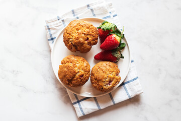 Strawberry muffins served in a plate on a marble background. Top view. - 535918860