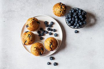 Blueberry muffins served in a plate on a marble background. Top view. - 535918887