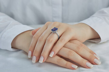 Gold sapphire ring on young woman hand