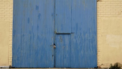 blue metal entrance of industrial warehouse background