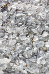 Background from a transparent glass stone. Artificial turf. Pieces of glass. Pure crystal quartz