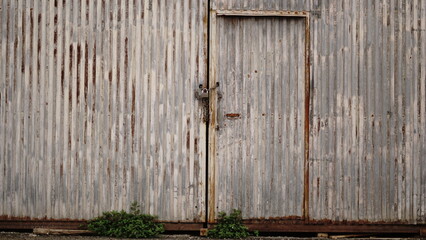 rusty industrial metal door of abandoned warehouse