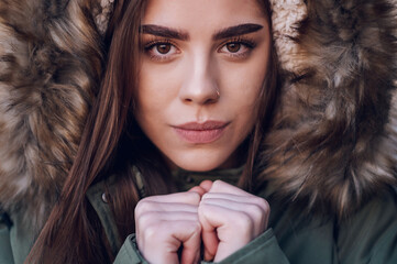 Portrait of a beautiful stylish young woman in a winter jacket