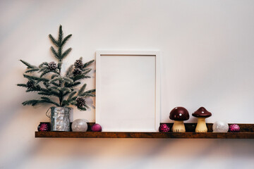 White frame and Christmas decorations on white background. Front view, mock up, copy space