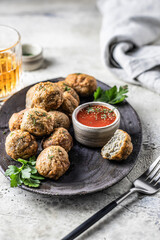 Cibriki potato fritters made from grated potatoes in balls form. Traditional Belarusian cuisine, served with sauce, herbs and cutlery in modern style. Menu, recipe