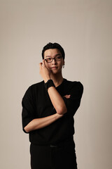 Young asian man with confident attitude posing on the white background. 