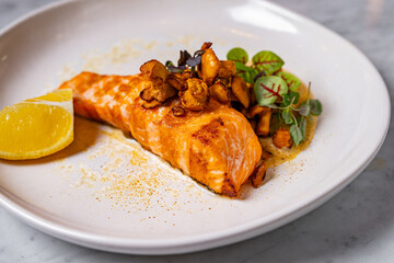 grilled salmon with mushrooms on a plate