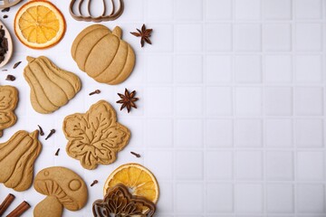Flat lay composition with tasty cookies, spices and cutters on white table, space for text