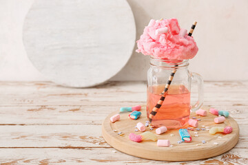 Mason jar with tasty cotton candy cocktail on wooden table