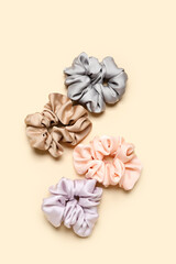Silk scrunchies on color background