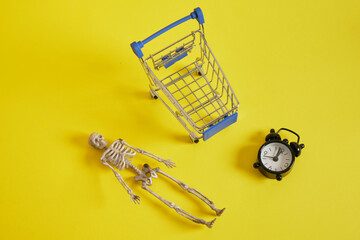 skeleton and shopping cart on yellow background