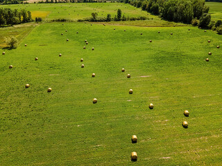 Elevated view over a rural field with bales of hay