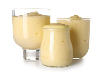 Glass containers of tasty vanilla pudding on white background