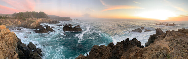 Waves crashing on rocks with sunset in Northern California 