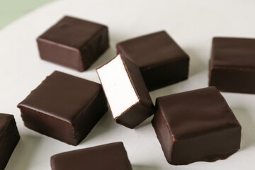 Tasty bird's milk candies on light background, closeup