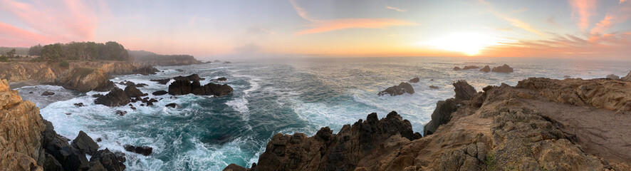 Waves crashing on rocks with sunset in Northern California 