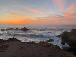 Waves crashing on rocks with sunset in Northern California 