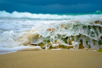 ocean waves foam over rock macro 16
