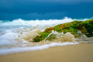 ocean waves foam over rock macro 9