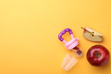 Nibbler with fresh apple on yellow background, flat lay. Space for text