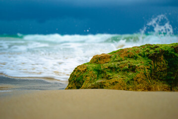 ocean waves foam over rock macro 