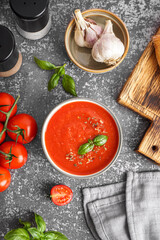 Bowl of delicious tomato soup on grunge background