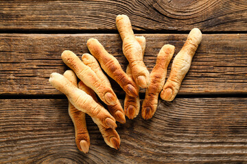 Halloween witch finger cookies on wooden background