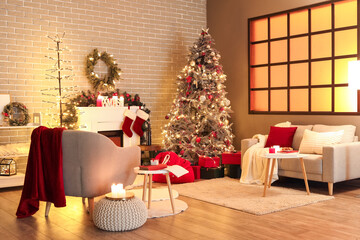 Interior of living room with armchair, sofa and Christmas tree