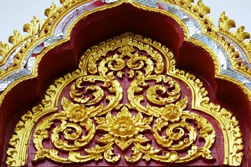 Golden Thai pattern, red background.