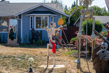 House yard decorated for Halloween with skulls, skeletons, guillotine, pirate ship