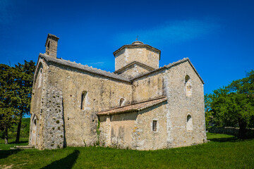 Fototapeta na wymiar View on the small romanesque church of Saint Pierre de Larnas in the South of France (Ardeche)