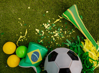 Above view of soccer ball and green and yellow party favors