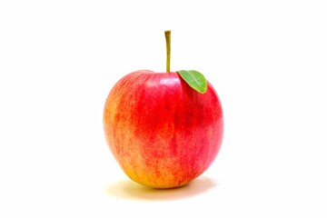 Solitary red apple with green leaves on white background.
