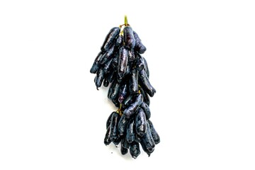Black grapes candied fruit isolated on white background.
