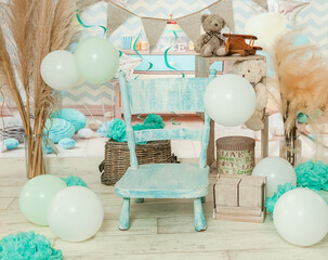 sliver, blue and white decoration for a 1st birthday cake smash studio photo shoot with balloons, paper decor. High quality photo