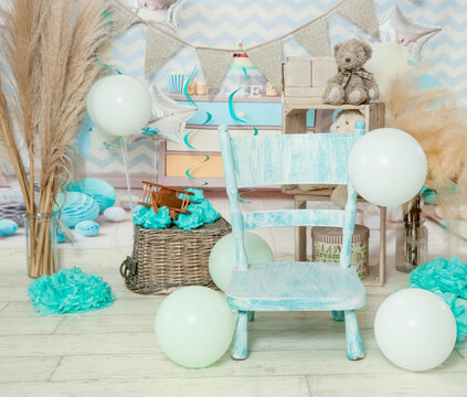 sliver, blue and white decoration for a 1st birthday cake smash studio photo shoot with balloons, paper decor. High quality photo