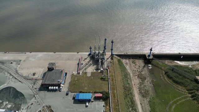 Aerial view of a gas and oil unloading terminal with pipeline, future site of an LNG terminal