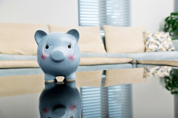 Blue piggy bank on living room table